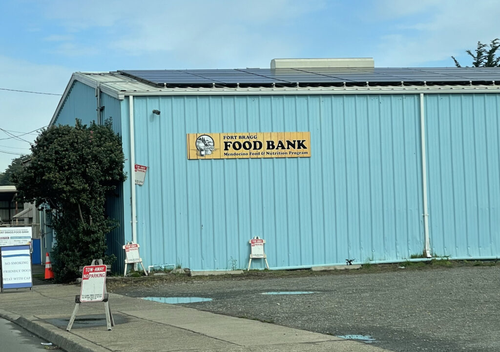Teal-colored one-story building with sign Fort Bragg Food Bank